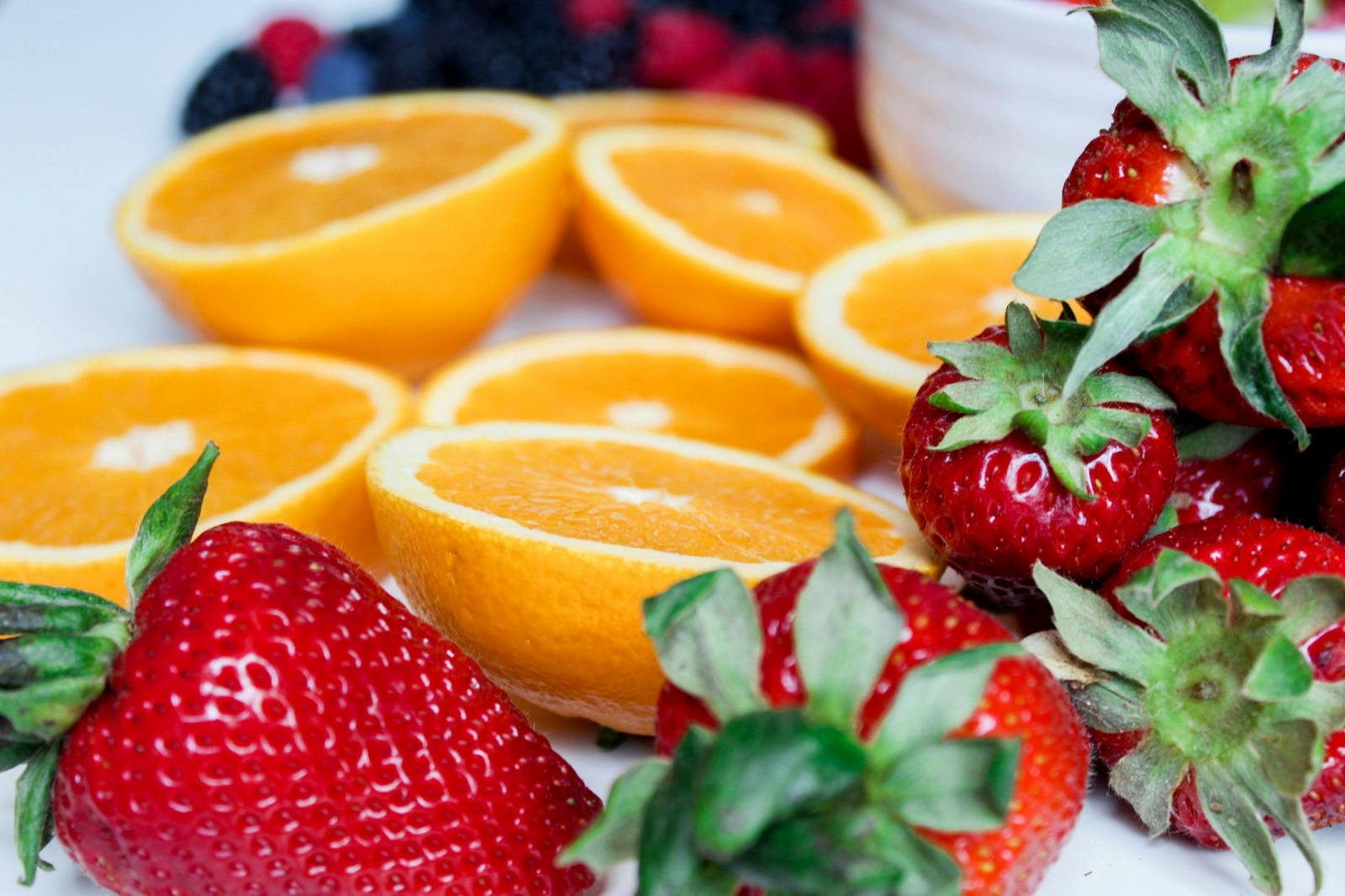 Detalle de fresas y naranjas frescas